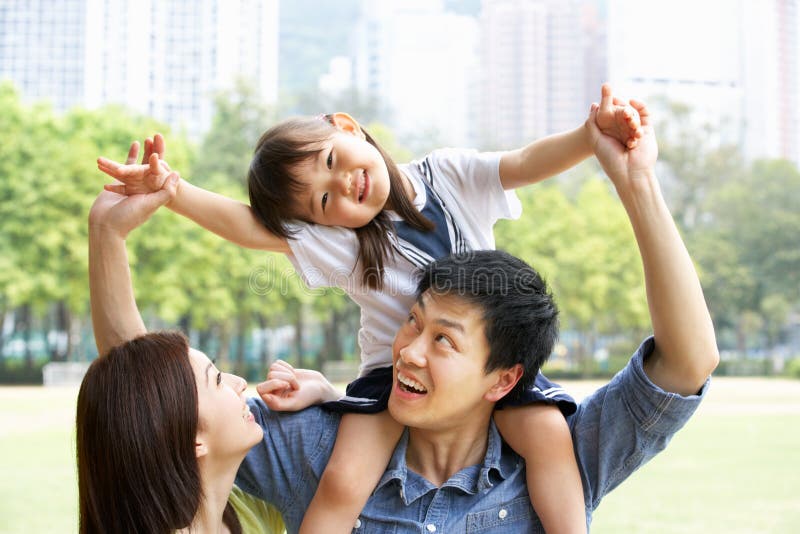 Chinesische Familie, die Tochter-Fahrt auf Schultern gibt