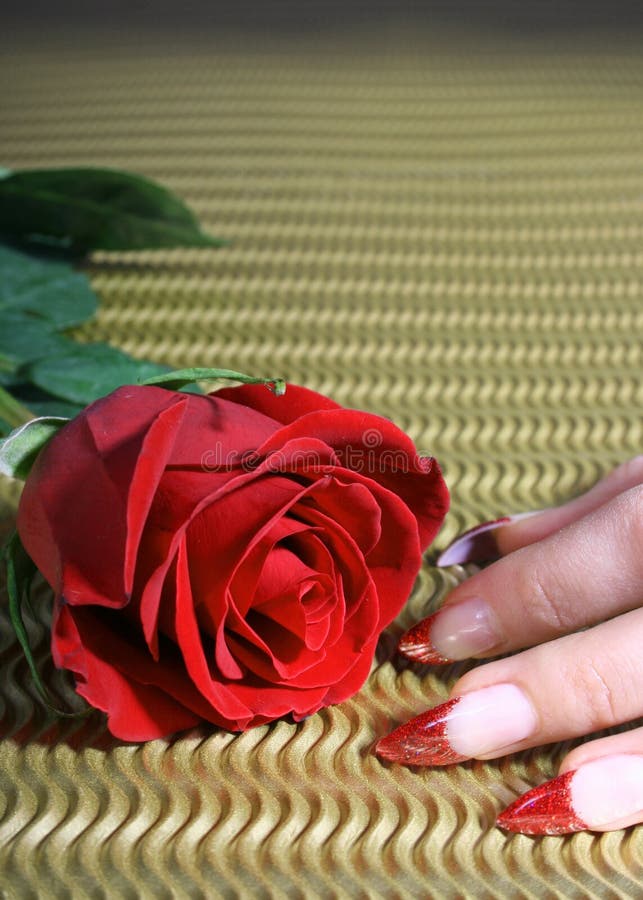 Red rose and nails on golden background. Red rose and nails on golden background
