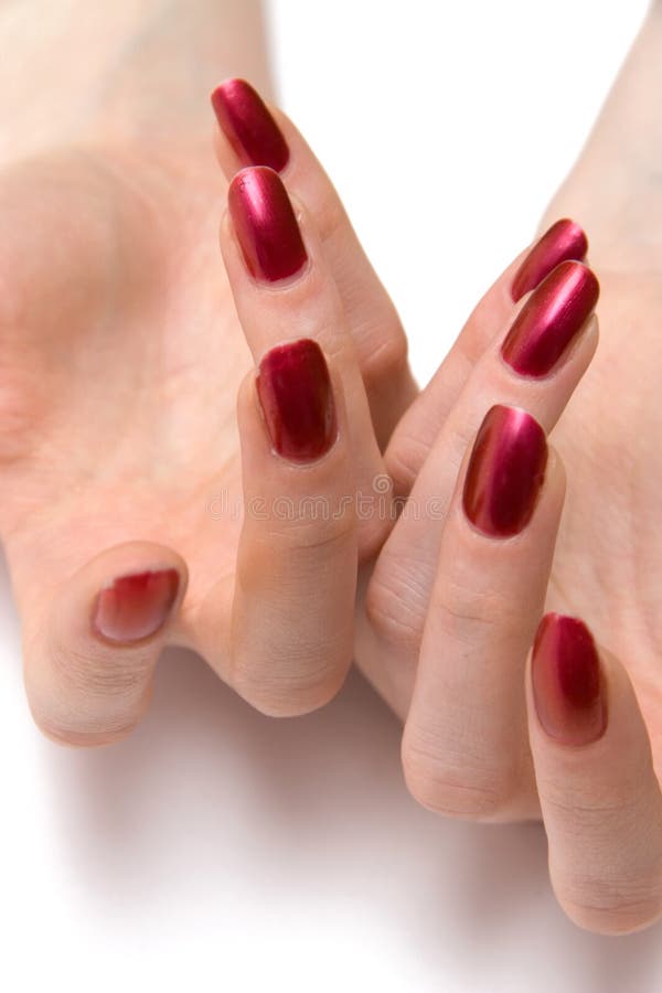 Chiodi rossi della donna su entrambe le mani fotografia stock Chiodi rossi della donna su entrambe le mani fotografia stock