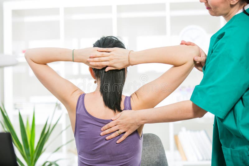 Chiropractor massage the female patient spine and back