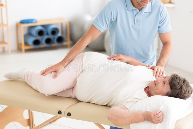 chiropractor-performing-back-adjustment-chiropractor-performing-back-bones-adjustment-senior-women-lying-table-114639164.jpg
