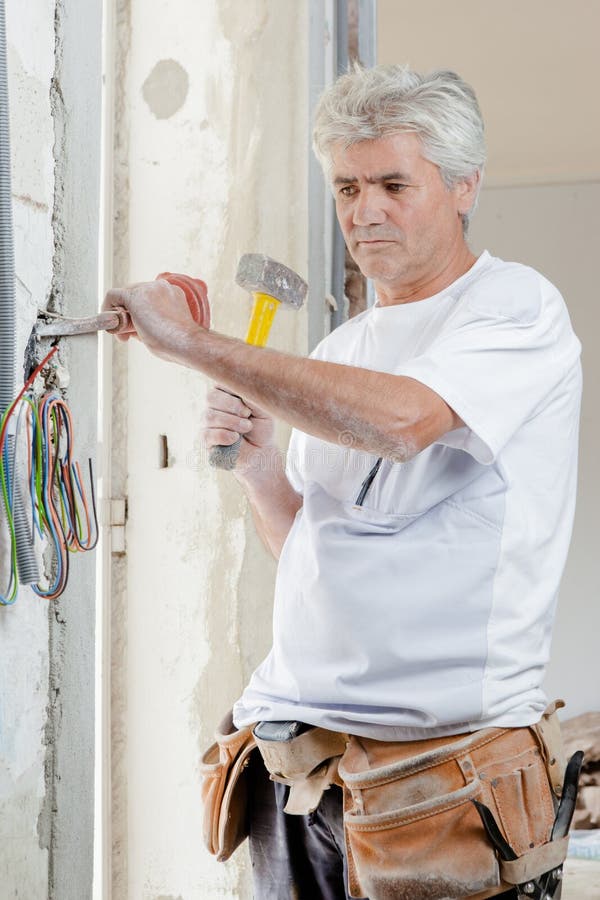 Chiseling at old wall stock image. Image of glove, person 103741281