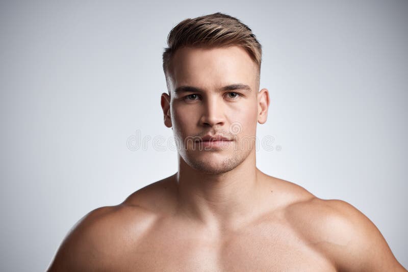 Chiselled like a prince. Studio portrait of a muscular young man posing against a grey background.