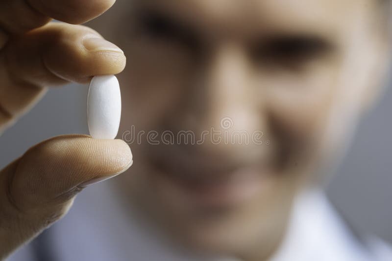 Chiuda su delle mani di medici che tengono una pillola fotografie stock libere da diritti Chiuda su delle mani di medici che tengono una pillola fotografie stock libere da diritti