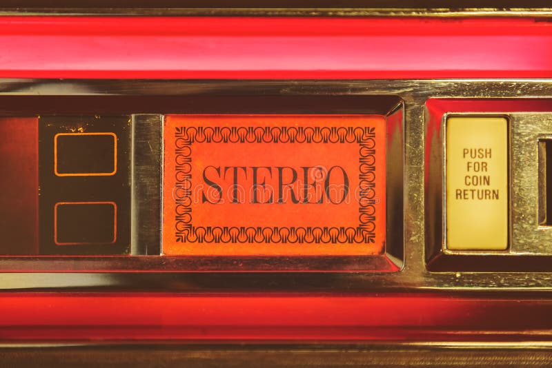 Close up of a vintage jukebox with the text stereo highlighted with red light. Close up of a vintage jukebox with the text stereo highlighted with red light