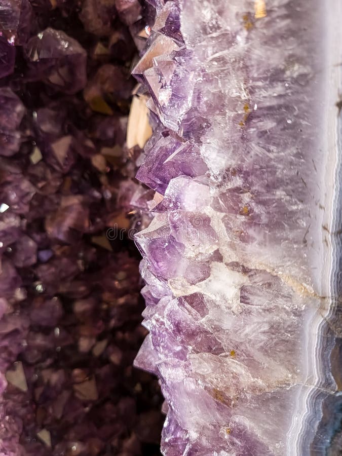 Amethyst geode close up of edge with crystals in background. Amethyst geode close up of edge with crystals in background