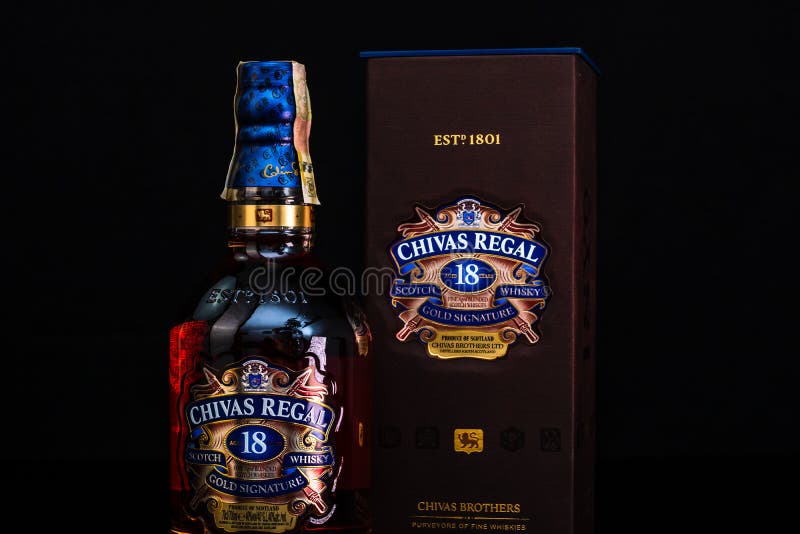 Chivas Regal 18 is blended from whiskies matured for at least 18 years. Whisky bottle on barrel. Illustrative editorial photo
