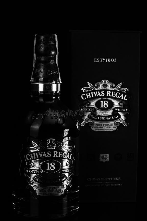 Chivas Regal 18 is blended from whiskies matured for at least 18 years. Whisky bottle on barrel. Illustrative editorial photo