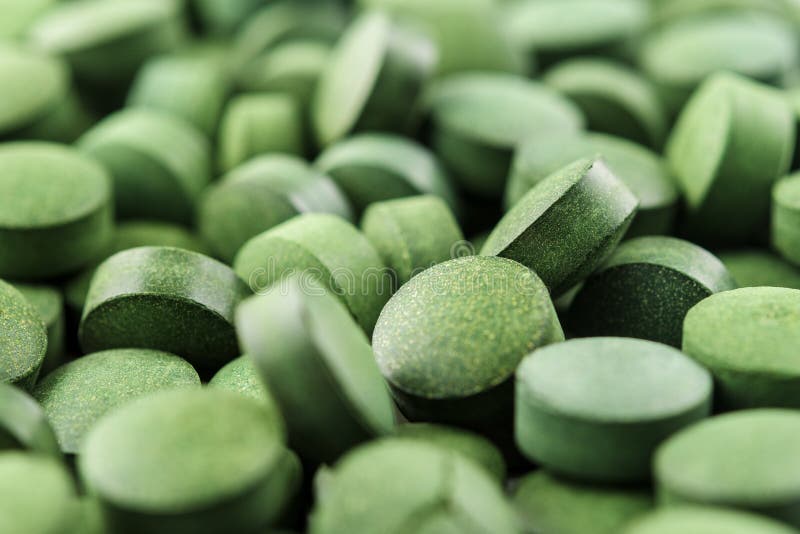 Chlorella or Spirulina Tablets Close Up. Texture of Tablets Spirulina or Chlorella Stock Photo