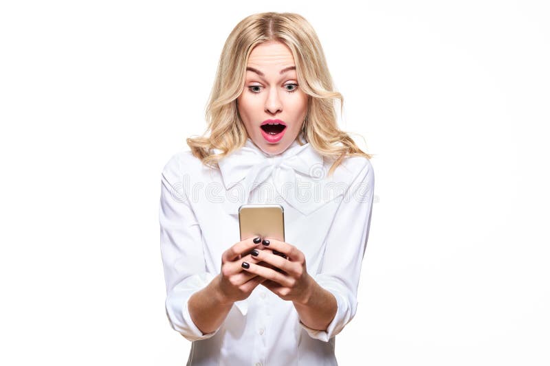 Shocked young woman looking at her mobile phone, screaming in disbelief. Woman staring at shocking text message on her phone, isolated over white background. Shocked young woman looking at her mobile phone, screaming in disbelief. Woman staring at shocking text message on her phone, isolated over white background.