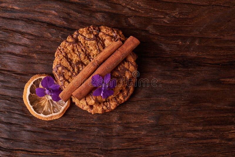 Chocoladekoekjes dichtbij bloem op de achtergrond van eik Het gezonde concept van het ochtendontbijt De minimalistische vlakte va stock fotografie Chocoladekoekjes dichtbij bloem op de achtergrond van eik Het gezonde concept van het ochtendontbijt De minimalistische vlakte va stock fotografie