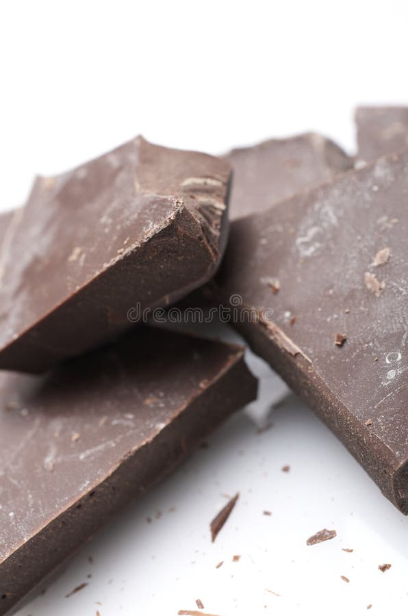 Foreground portions of chocolate on a white surface. Dessert portions stock images, royalty-free photos and pictures