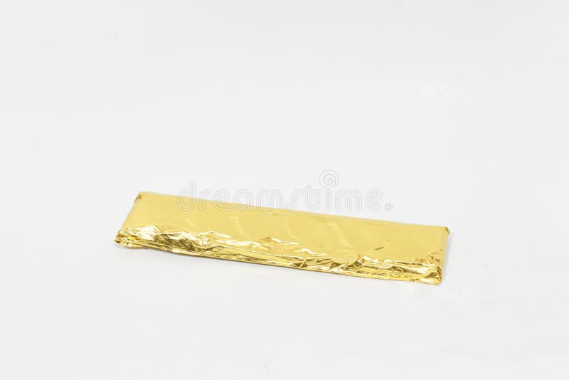 A Chocolate Bar Wrapped in Gold Aluminium Wrapping Stock Photo Image