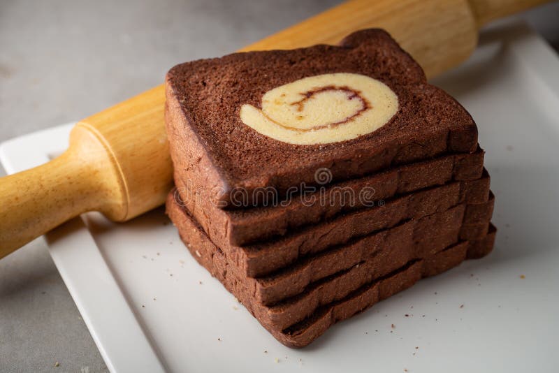 Chocolate Bread Stuffed with Jam Rolls Topped with Chocolate Sauce