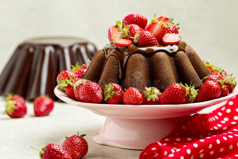 Chocolate Cake. Decorating with Chocolate Icing and Strawberries Stock