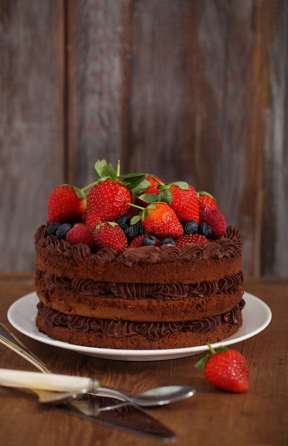 Chocolate cake with icing and fresh berry