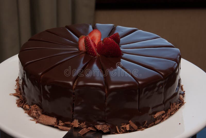 Chocolate Cake. Rich milk chocolate cake with strawberry topping royalty free stock photo