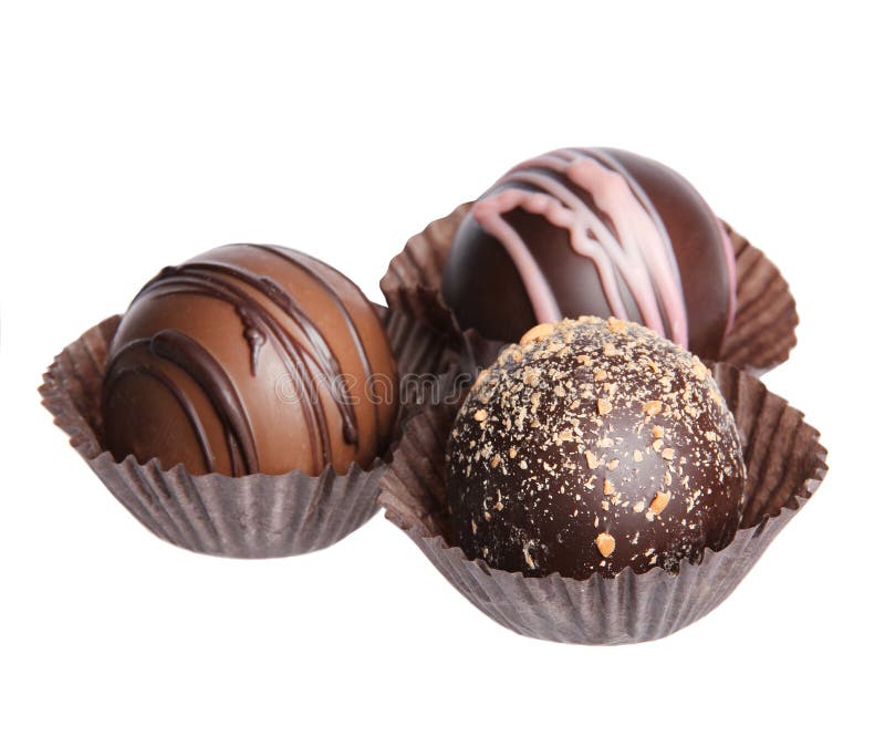 Chocolate candies. Collection of beautiful Belgian truffles in wrapper isolated