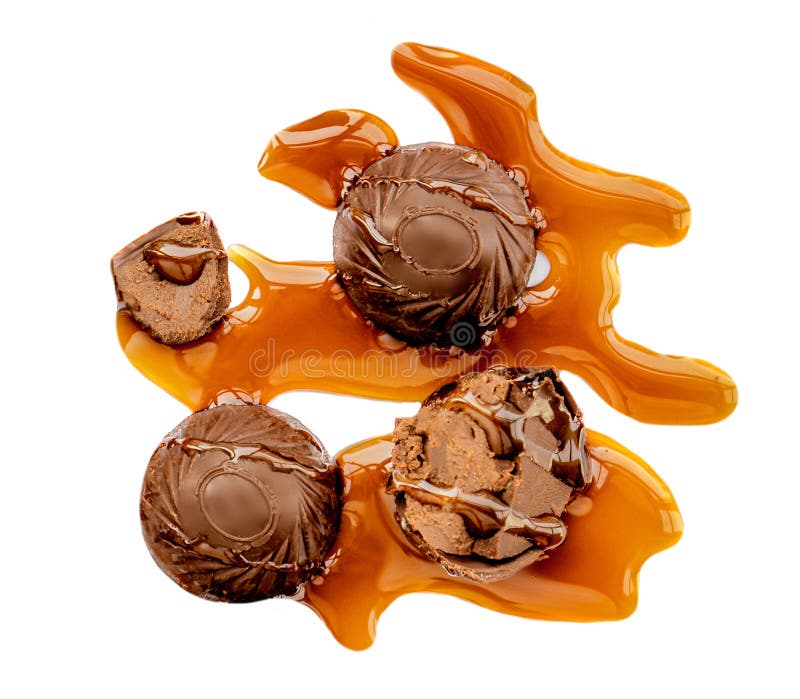 Chocolate candies covered with melting caramel isolated on white background. Top view stock photography.