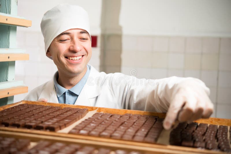 Chocolate candy making stock image. Image of hand, product 132204001