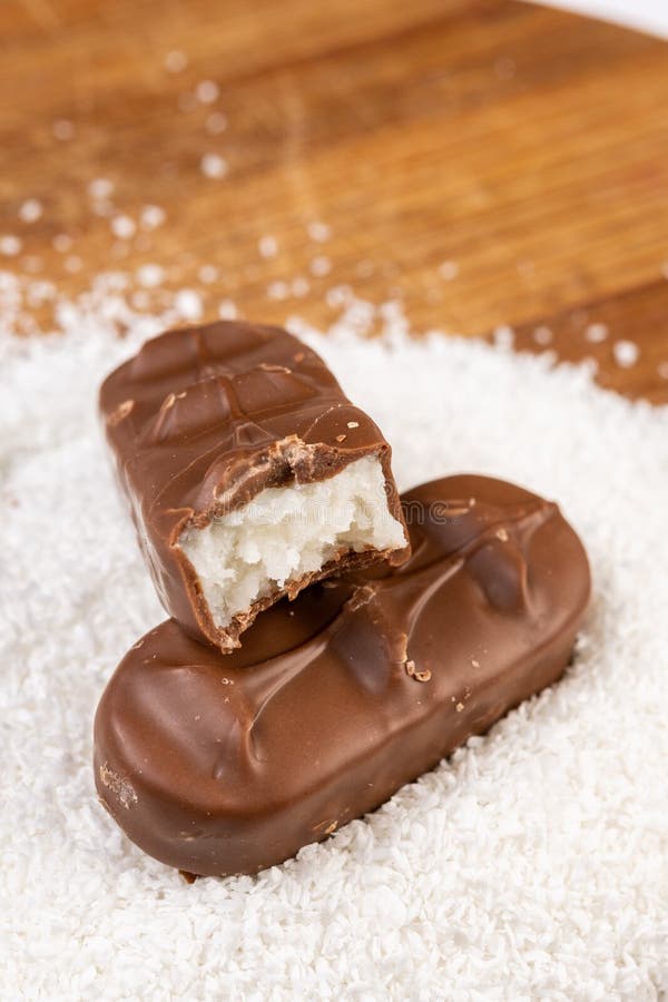 Chocolate candy above ground coconut on the wooden board stock image Chocolate candy above ground coconut on the wooden board stock image