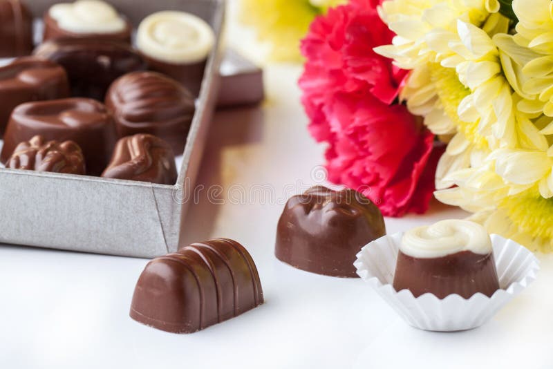 Chocolate Candy and Flowers Over White Stock Photo Image of