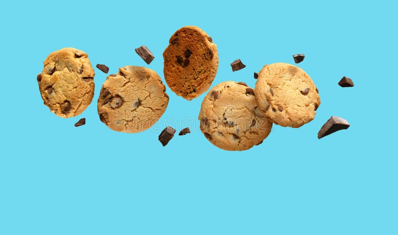 Chocolate chip cookies flying over aqua blue background. Copy space