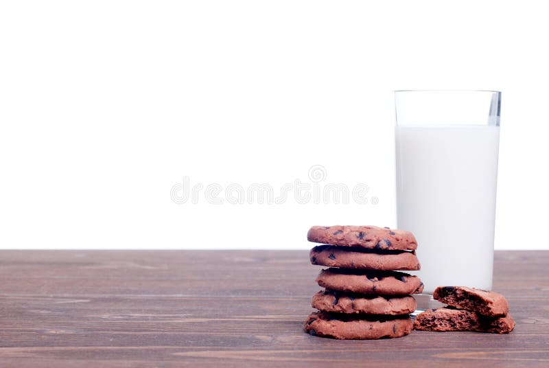 Chocolate chip cookies with milk on the board side view