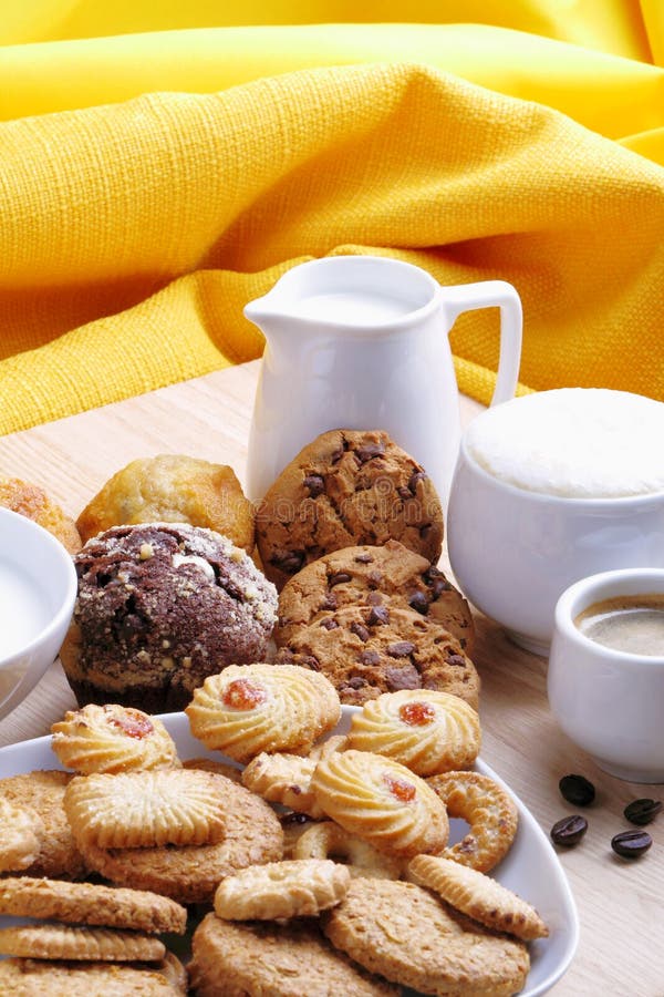 Chocolate chip cookies, muffins, small pastries with coffee and milk