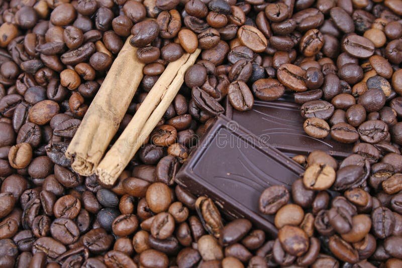 Chocolate and cinnamon on coffee beans background