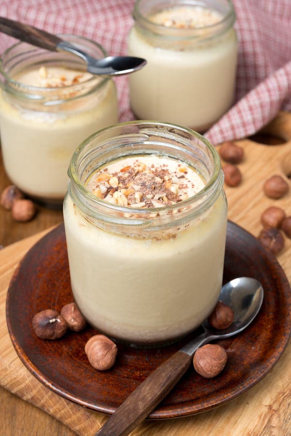 Chocolate and coffee yogurt with nuts in portions jars, vertical. Dessert portions stock images, royalty-free photos and pictures