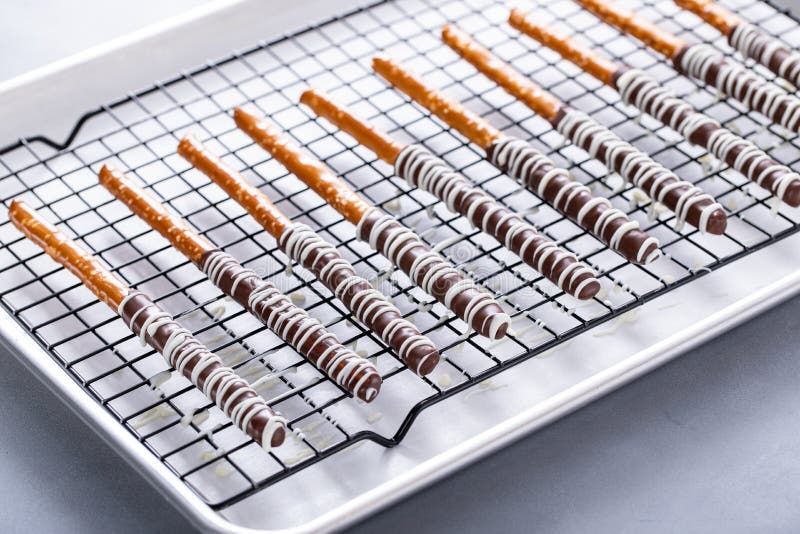 Chocolate Covered Pretzel Rods Freshly Made on a Cooling Rack Stock