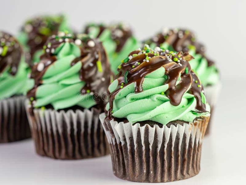 6 Chocolate Cupcakes with Mint Green Frosting and Chocolate Drizzle and Sprinkles stock photos 6 Chocolate Cupcakes with Mint Green Frosting and Chocolate Drizzle and Sprinkles stock photos
