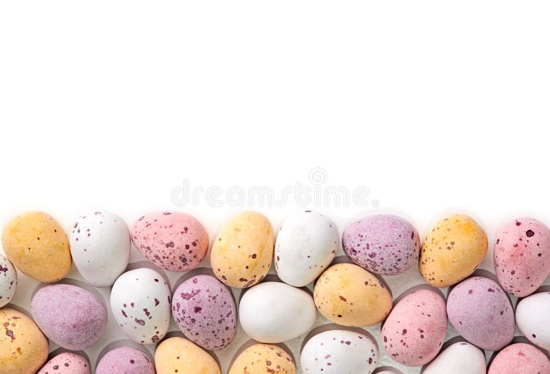 A selection of chocolate Easter Eggs with a candy crunchy shell on a white background.