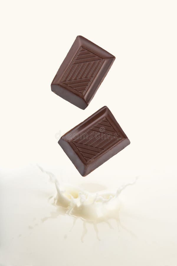 Chocolate falling into milk