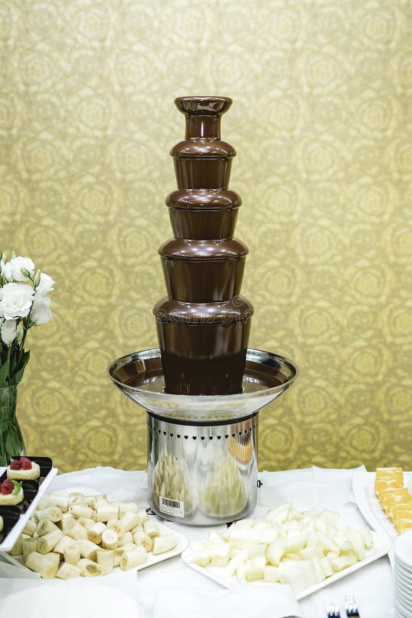 Chocolate Fountain Hot Liquid Flowing Down Tower Pyramid Stock Image