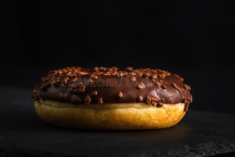 Chocolate Glazed Donut with Chocolate Chips Isolated. Close Up of