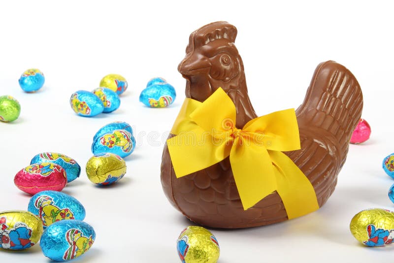 Chocolate hen with yellow ribbon and colorful Easter eggs, isolated on white background stock image Chocolate hen with yellow ribbon and colorful Easter eggs, isolated on white background stock image