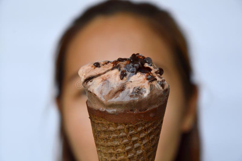 Chocolate ice cream in front of woman royalty free stock images