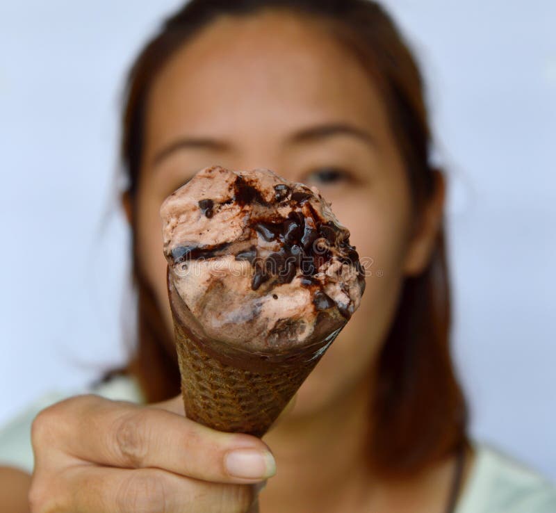 Chocolate ice cream in front of woman royalty free stock photos