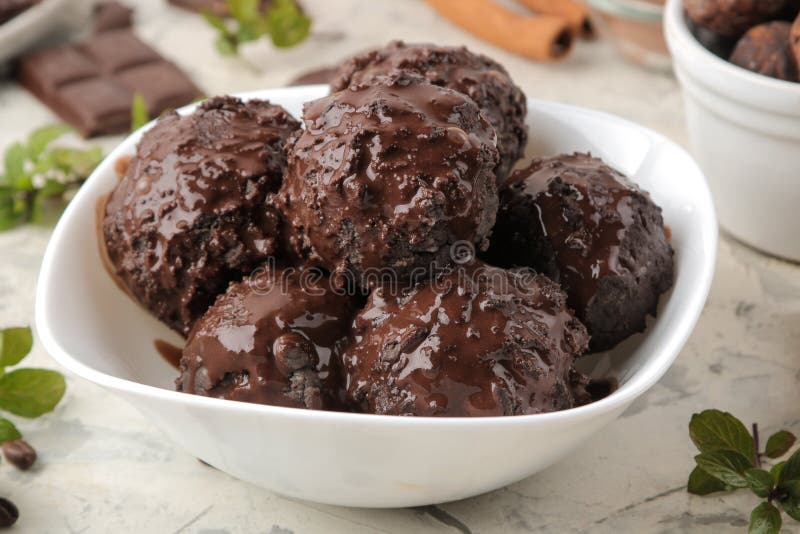 Chocolate Ice Cream with Liquid Chocolate on a Light Concrete