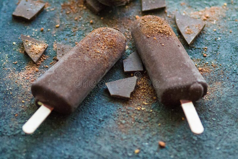 Chocolate Ice Cream with Pieces of Chocolate on a Concrete Background
