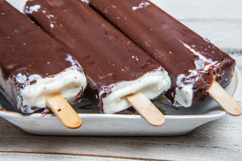 Chocolate Ice Cream Pops on a Blue Wooden Background. Chocolate Ice