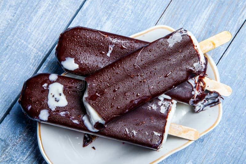 Chocolate Ice Cream Pops On A Blue Wooden Background. Chocolate Ice