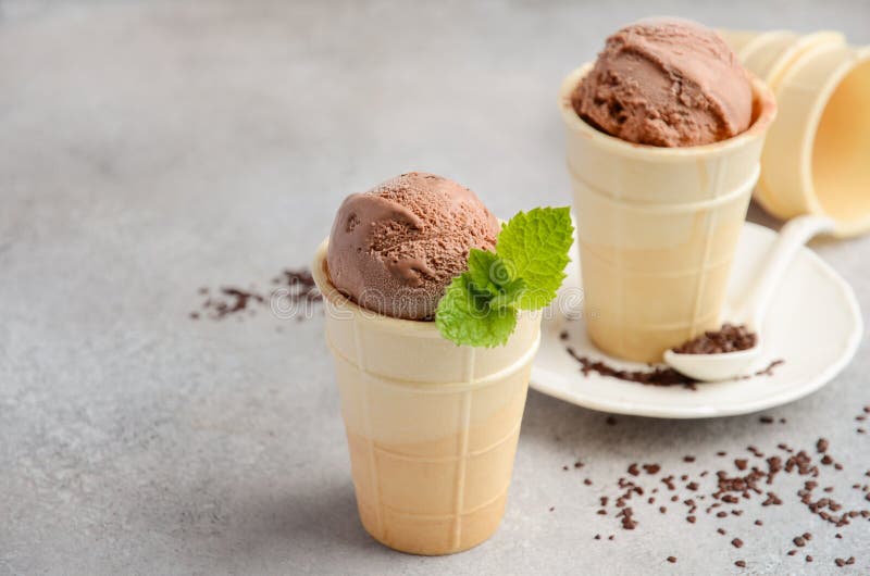 Chocolate Ice Cream in Waffle Cone on Grey Concrete Background Stock