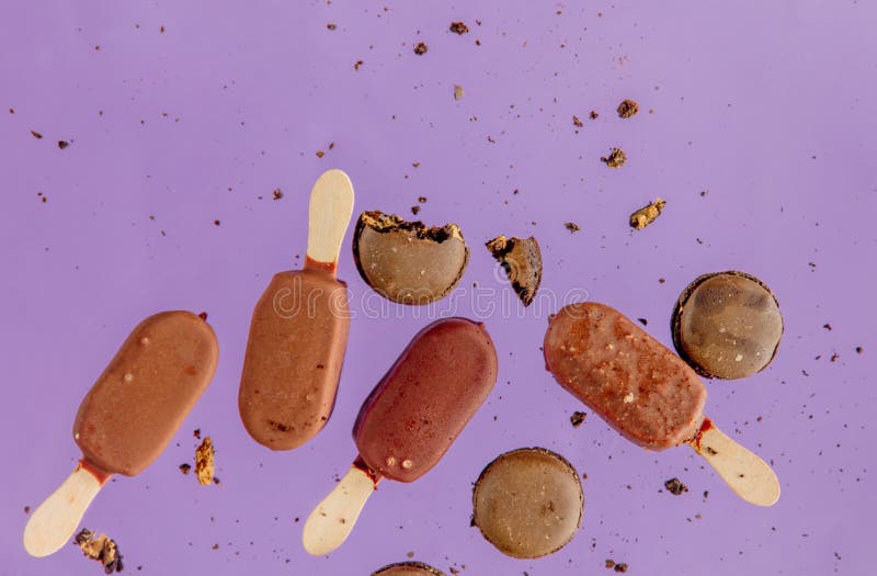 Chocolate Ice Lolly and French Macrons on Purple Background. Stock