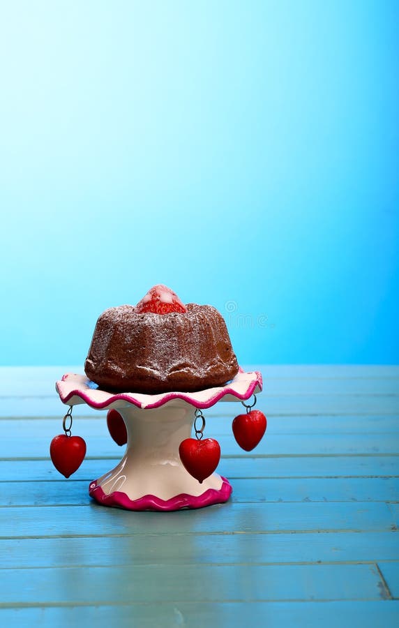 Chocolate Mini Pound (Bundt) Cake with Strawberry and Icing Sugar on Stand with Hearts