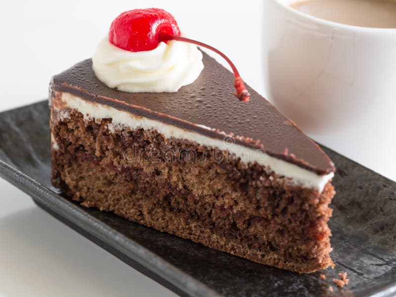 Chocolate Mousse Cake with Whipping Cream and Cherry Topping. Stock