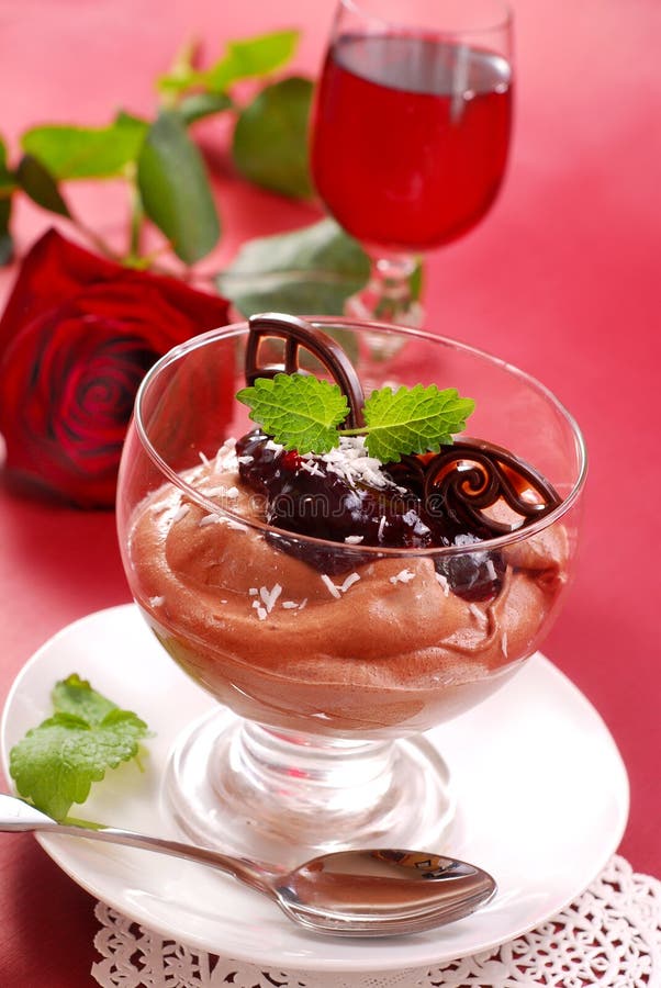 Chocolate mousse dessert with black currant confiture in glass. Chocolate mousse dessert with black currant confiture in glass