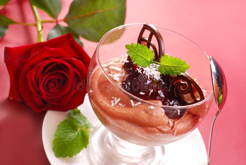 Chocolate mousse dessert with black currant confiture in glass. Chocolate mousse dessert with black currant confiture in glass